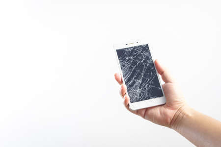 Man hand holding mobile phone with broken screenの写真素材