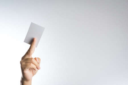 Hand hold blank card or paper on white backgroundの写真素材