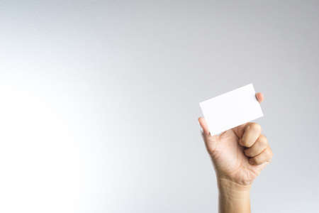 Hand hold blank card or paper on white backgroundの写真素材