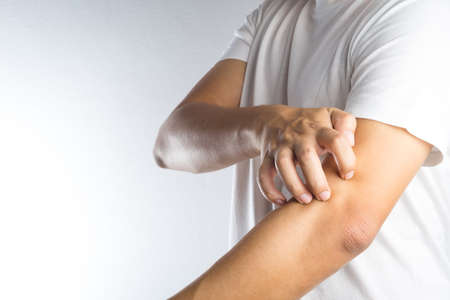 Man scratch the itch with hand