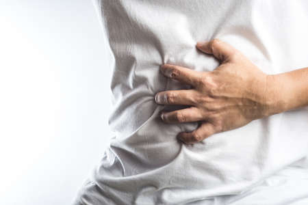 Man with stomach pain on white background