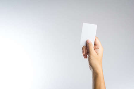 Hand hold blank card or paper on white backgroundの写真素材