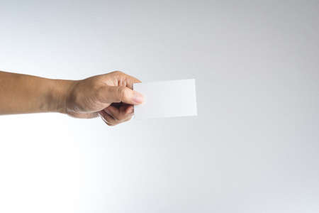 Hand hold blank card or paper on white backgroundの写真素材