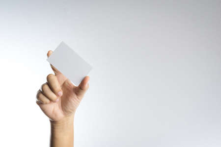 Hand hold blank card or paper on white backgroundの写真素材