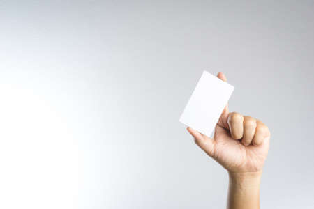 Hand hold blank card or paper on white backgroundの写真素材