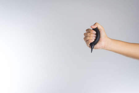 Hand holding camera air blower on white backgroundの写真素材