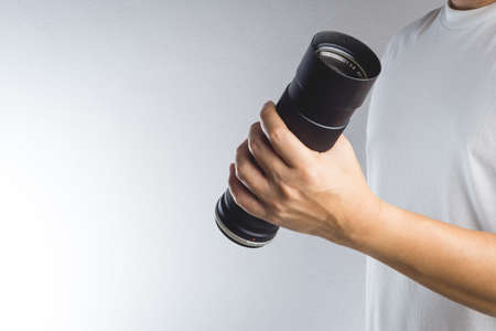 Hand holding vintage camera len on white backgroundの写真素材