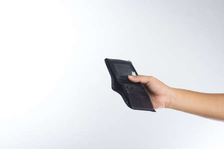 Hand holding empty old wallet on white backgroundの写真素材