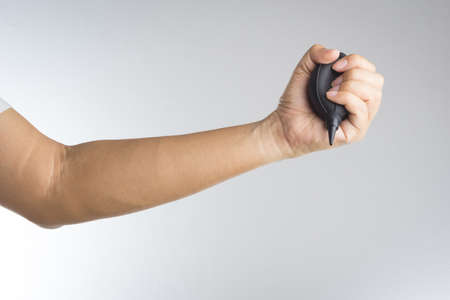 Hand holding camera air blower on white backgroundの写真素材