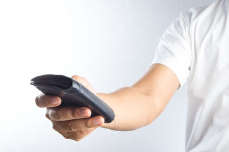 Hand holding old wallet on white backgroundの写真素材