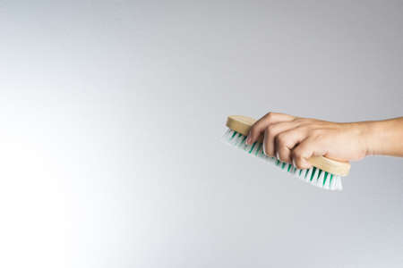 Hand holding brush on white backgroundの写真素材