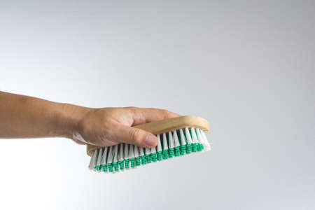 Hand holding brush on white backgroundの写真素材