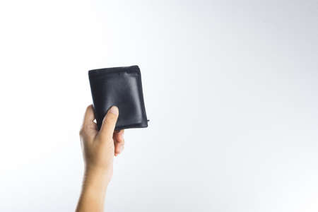 Hand holding old wallet on white backgroundの写真素材