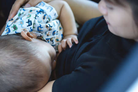 A year old Asian baby Breastfeeding by his motherの写真素材