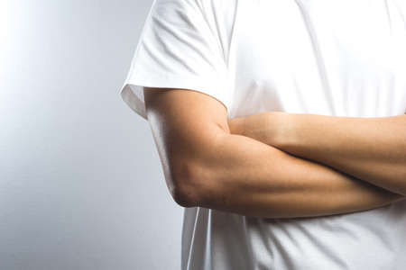 A man with arms crossed on white backgroundの写真素材