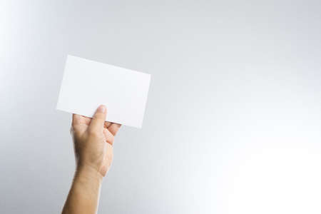 Hand hold blank photo paper card  on white backgroundの写真素材