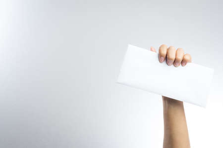 hand holding envelope on white backgroundの写真素材