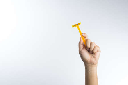 Hand with shaving razor on white backgroundの写真素材