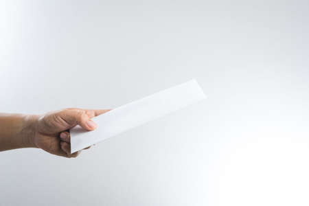 hand holding envelope on white background