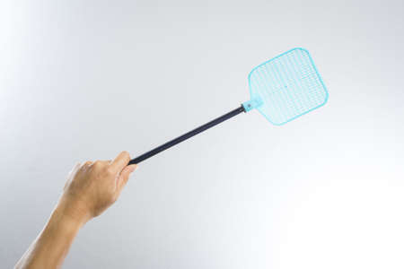 hand holding fly or insect swatter on white backgroundの写真素材