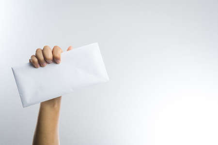 hand holding envelope on white background