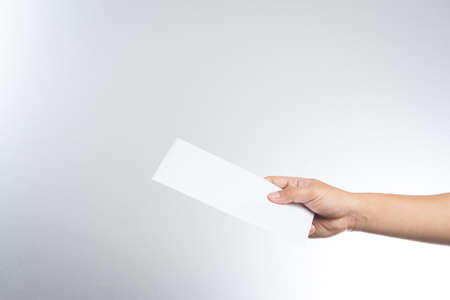 hand holding envelope on white backgroundの写真素材