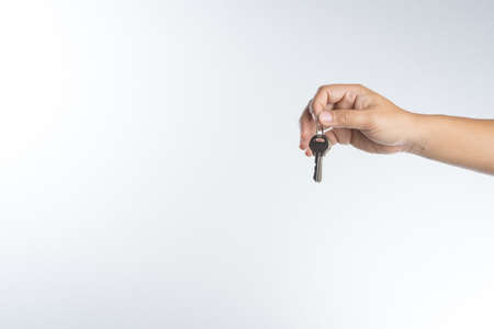 Hand giving keys on white backgroundの写真素材