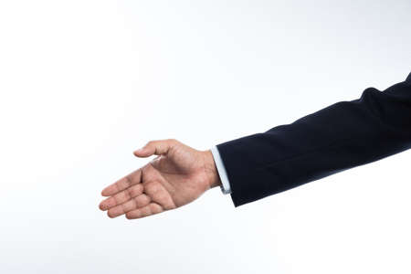 Business man with right hand reaching out for shake hands on white background