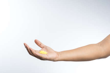 Hand full of pills on white backgroundの写真素材