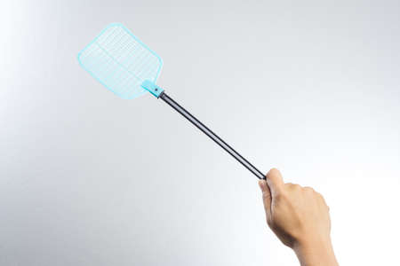 hand holding fly or insect swatter on white backgroundの写真素材