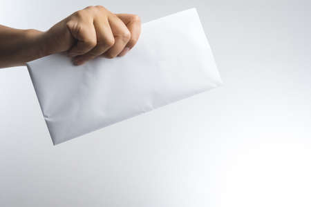 hand holding envelope on white backgroundの写真素材