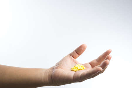 Hand full of pills on white backgroundの写真素材