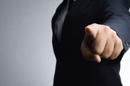 Businessman aggressive pointing index finger on white background
