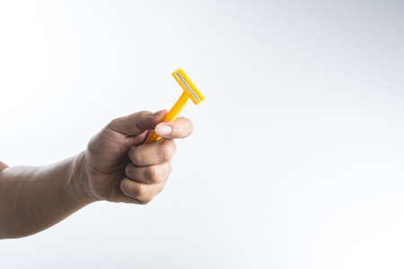 Hand with shaving razor on white backgroundの写真素材