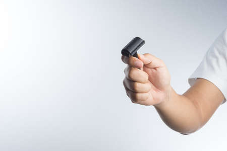 Hand with vintage shaving razor on white background