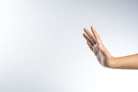 hand with stop gesture on white backgroundの写真素材