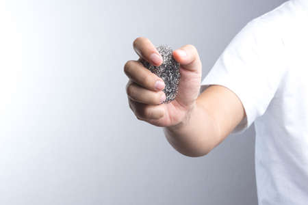 A Hand holding steel woolの写真素材