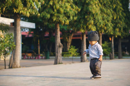 Asian boy about 1 year and a month learning to walk and fall on his ownの写真素材