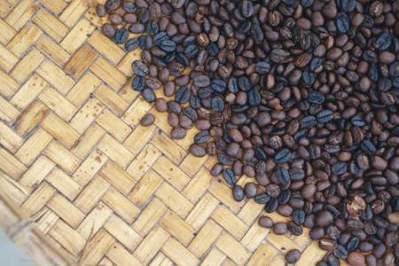 Third processing of vintage coffee bean by roasted in clay pot over charcoalの写真素材