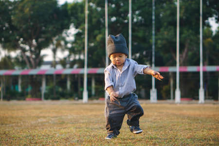 Asian boy about 1 year and a month learning to walk and fall on his ownの写真素材