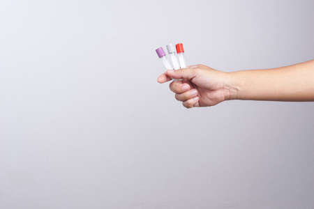 Hand holding empty test tube on white backgroundの写真素材