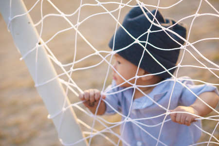 Asian boy about 1 year and a month learning to walk and fall on his ownの写真素材