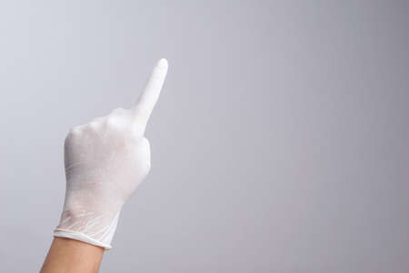 Hand wearing latex glove with number one index finger on white backgroundの写真素材