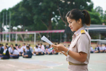 Thai teacher in official uniform on morning duty