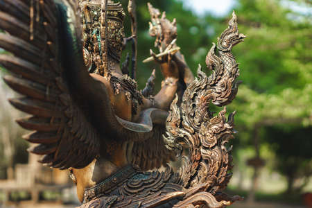 Bronze statue of Garuda of Asian culture in Thai public parkの写真素材