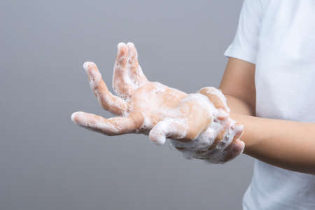 Gesture of a woman hand washing her hands on step 5 on grey background