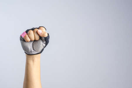 A hand wearing bicycle glove with clenched fist sign on white backgroundの写真素材
