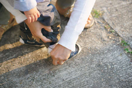 Asian mother teach her 1 year and a month son to walk, life concept