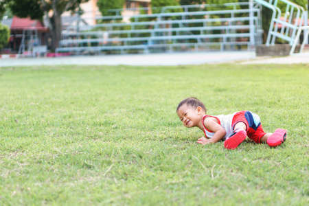 Asian boy about 1 year and 4 months learning to walk and fall on his ownの写真素材