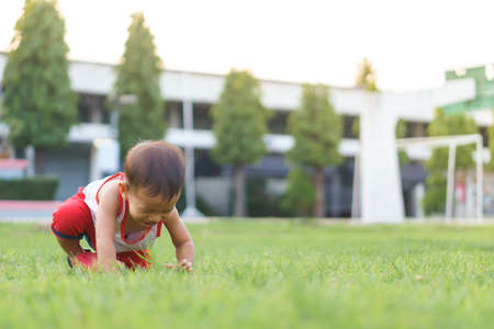 Asian boy about 1 year and 4 months learning to walk and fall on his ownの写真素材